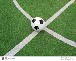 football ball over green soccer field