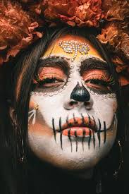 a young woman in sugar skull makeup for