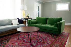 green couch and pink rug