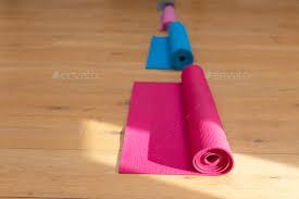 rolled up exercise mats arranged in a