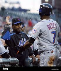 New York Mets manager Willie Randolph, left, congratulates Jose Reyes as he  returns to the dugout after scoring on a sacrifice fly by Carlos Beltran in  the first inning og a baseball