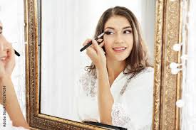 mirror and applying makeup stock photo