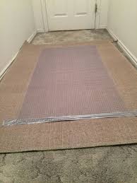 how to secure an area rug over carpet