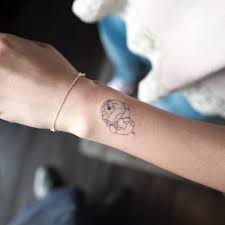Astronaut Doraemon tattoo on the wrist.