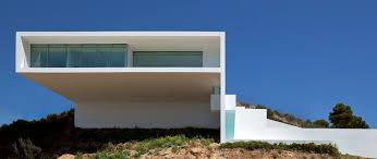 monolithic house suspended above the sea