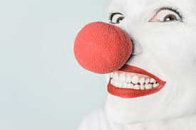 pink lipstick and red nose clown