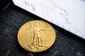 Closeup Of Golden American Eagle Coin With A Chart Reflection