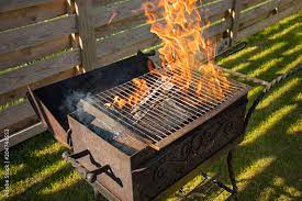 wood burning inside a barbecue grill