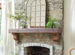 wood mantel on a stone fireplace