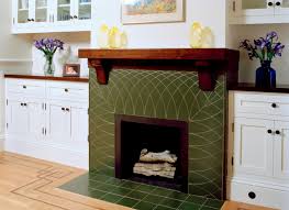 green tile fireplace with wood mantel