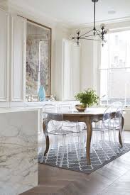 an antique table and modern chairs