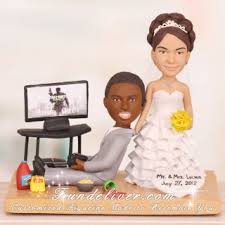 There are many reasonably priced custom shapes and sizes: Groom Playing Ps3 Gamer Theme Wedding Cake Toppers