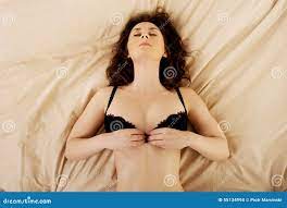 Brunette Woman Taking Off Her Bra. Stock Photo - Image of female,  attractive: 55134994