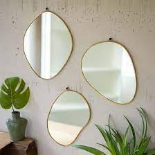 brass framed organic shaped mirrors