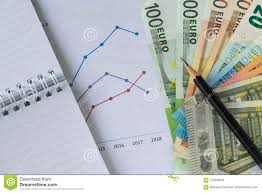 Pencil On Pile Of Euro Banknotes With Printed Chart Graph