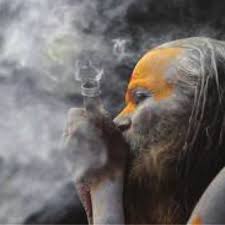 a sadhu ritually smoking cans