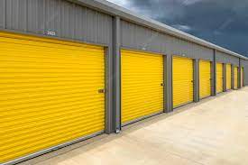 Premium Photo | Exterior of a commercial warehouse with yellow roller doors  garages self storage facilities