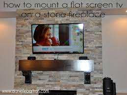 flat screen tv on a stone fireplace