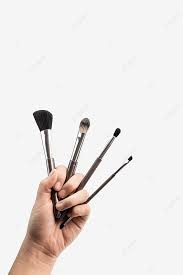 hand holding beauty tools makeup brush