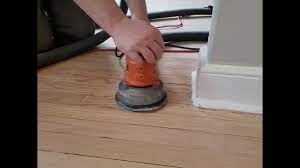 sanding hardwood floor with an orbital