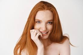 flirty redhead woman with pale skin