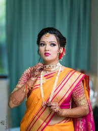marathi bride wearing an orange saree