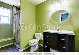 Adding a seat that is tiled to your vanity can change the decor of your bathroom. Bright Green Bathroom Interior With Brown Bathroom Vanity Cabinet And Mirror Canstock