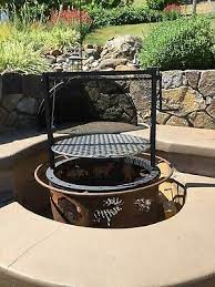 The solid steel griddle is perfect for toasting buns, frying bacon, eggs, or even making pancakes once the grate has been well seasoned. Fire Pit Barbecue Attachment Santa Maria Style Crank Style Adjustable Grate Ebay