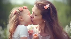 woman kissing her little on the