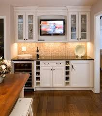bar with white cabinets tv display