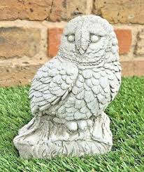 stone owl bird on rock garden ornament