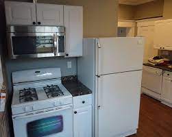 If you're installing new floors in the area where you're adding cabinets, this is the time to do it. File Kitchen Renovation Project Cabinets Finished Microwave Installed New Floor Painted Walls And Ceiling Jpg Wikimedia Commons