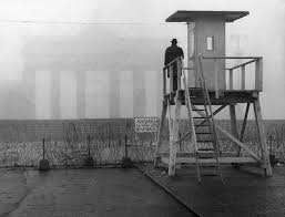 the story of berlin wall in pictures  the brandenburg gate is shrouded in fog as a man looks from a watchtower over the wall to the eastern part of the divided city on 25 1961