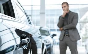 Man at car dealership in saskatoon thinking about buying a car