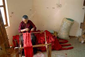 tibetan carpet maker stock image