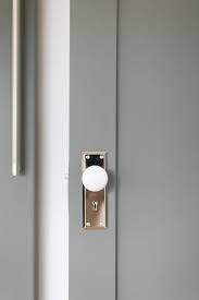 white glass door knob on gray wooden