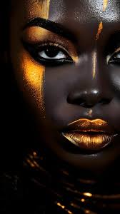 a woman with gold makeup and black skin