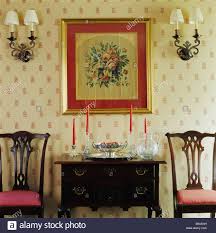 Wall Lights On Either Side Of Framed Floral Tapestry Above
