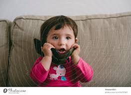 baby playing with two mobilephones