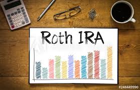 Overhead Top View Of Roth Ira Written In Book On Desk With A