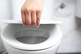Man S Hand Opening The Toilet Lid