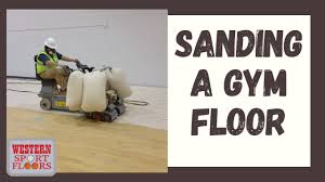 the process of sanding a gym floor