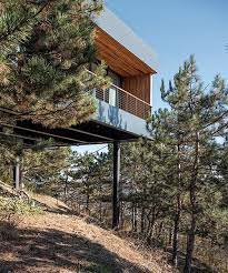 Hillside House On Stilts By Two
