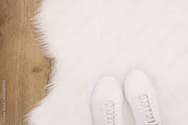 white women sneakers on white fur