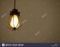 Yellow Illuminated Hanging Light Bulbs On Brown Plain Background