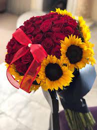 What do rose flowers symbolize? 5 Dozen Red Roses And Sunflowers Bouquet By Compton Flower Shop