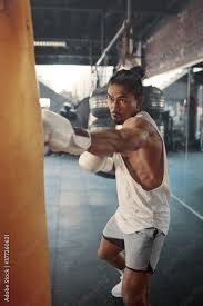 boxing workout man at gym punching bag