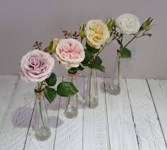 pastel silk roses in tall glass vase