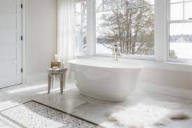 glossy white oval bathtub on marble