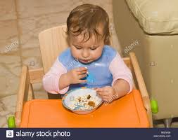 One Year Old Toddler Feeding Herself Stock Photo 21203372